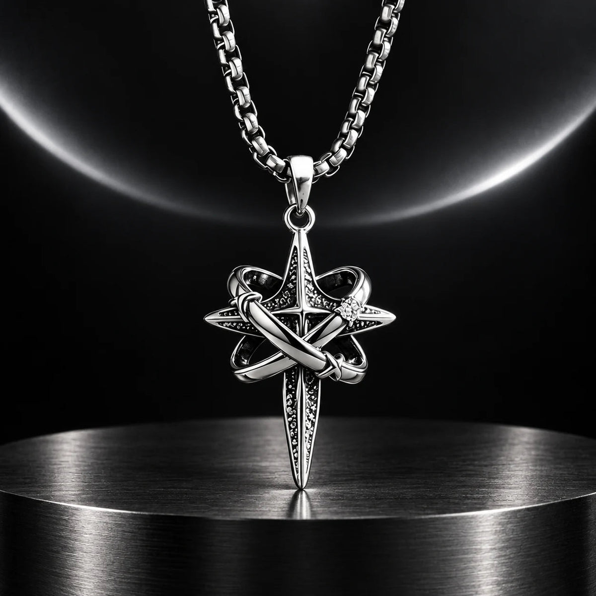 Orbit Cross Necklace — silver-tone product in a dark chrome studio setting