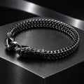 Twin Serpent Bracelet — Dark silver tone in a dark chrome studio setting