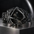 Spiderweb Watch — Black in a dark chrome studio setting