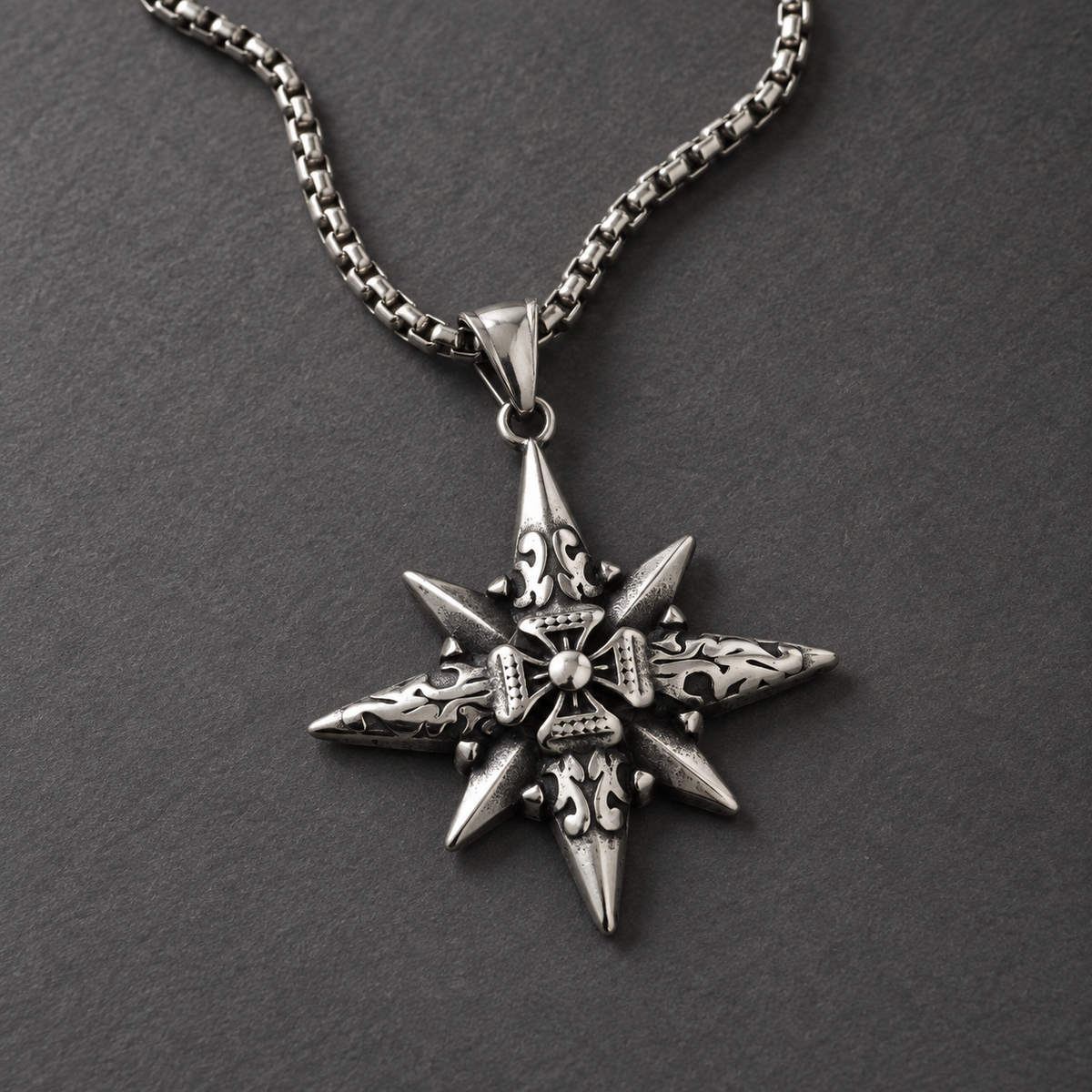 Vesper Cross Necklace with natural silver highlights on a matte graphite surface